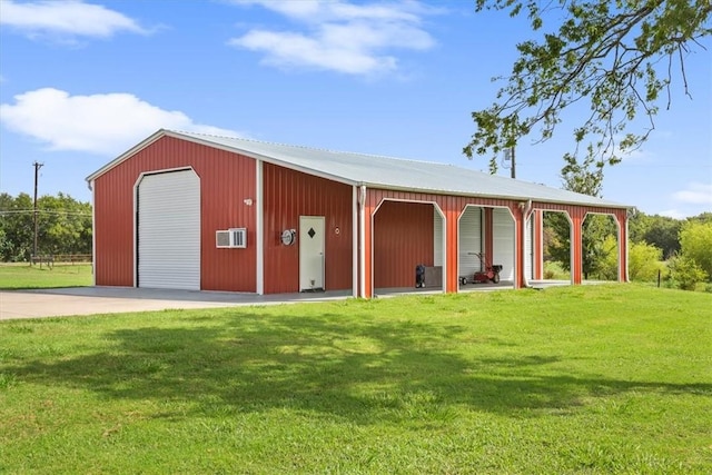 exterior space with an outbuilding, a garage, and a front yard