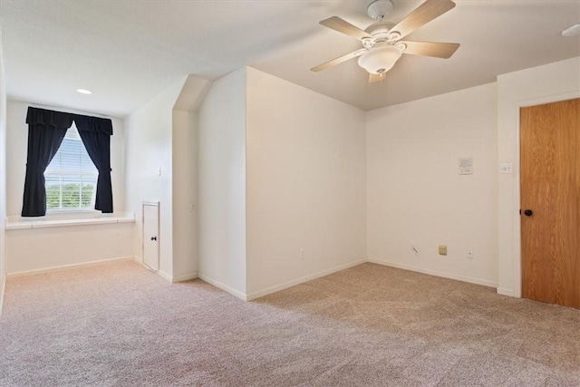 bonus room featuring ceiling fan and light carpet