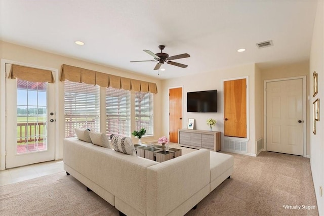 carpeted living room featuring ceiling fan