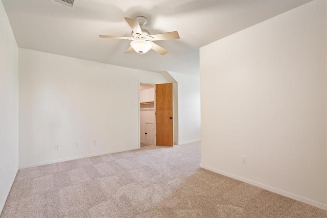 empty room featuring ceiling fan and light colored carpet