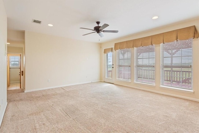 spare room with light carpet and ceiling fan