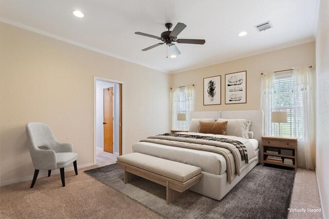 carpeted bedroom with ceiling fan and crown molding