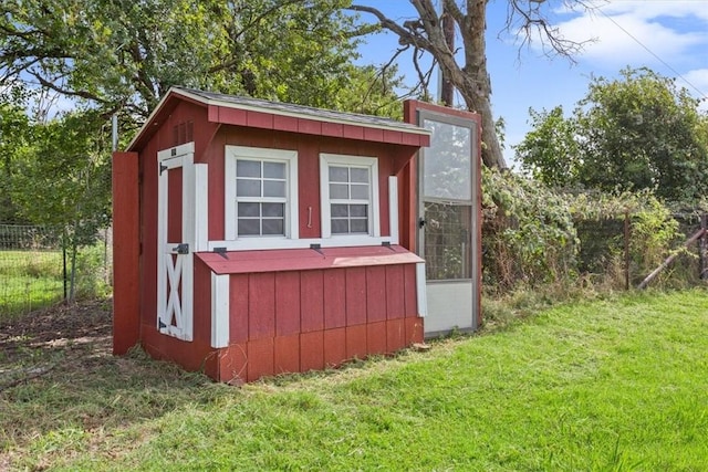 view of outbuilding featuring a yard