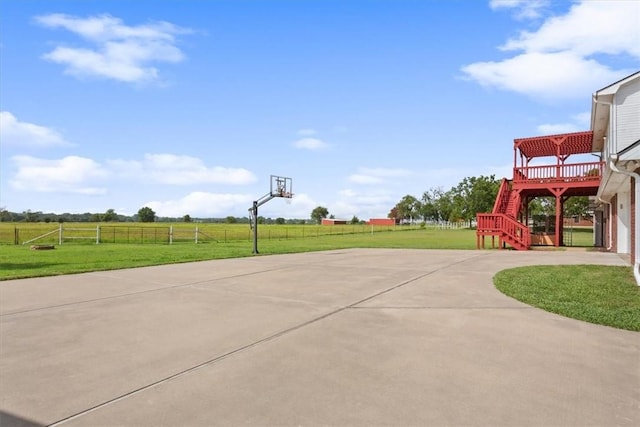 view of basketball court with a yard