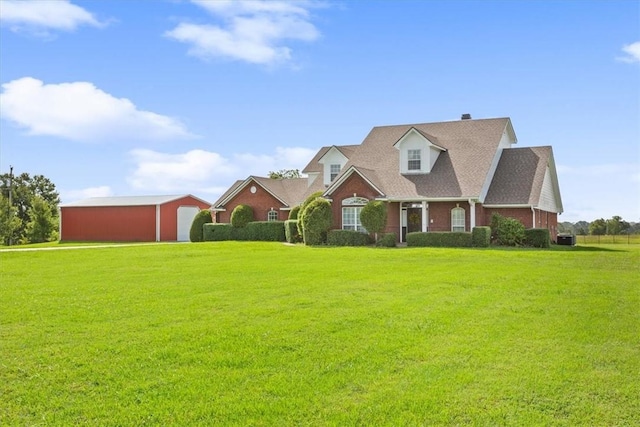 cape cod-style house with a garage, an outbuilding, and a front lawn