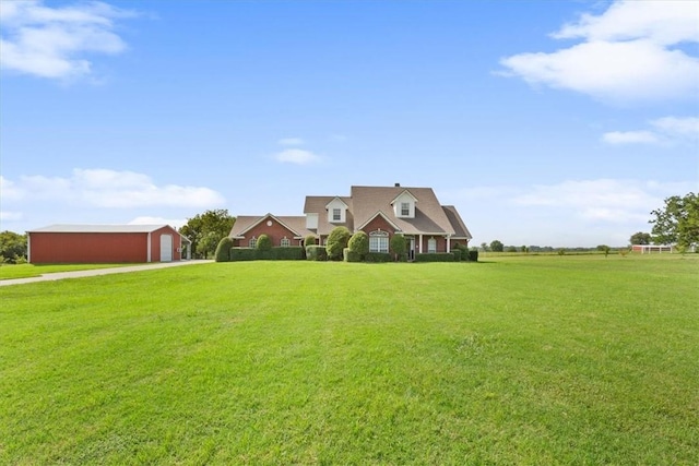 cape cod-style house featuring an outbuilding and a front yard