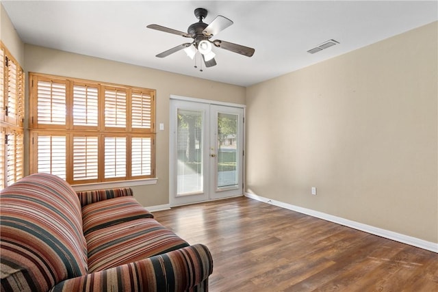 interior space featuring french doors, ceiling fan, plenty of natural light, and dark hardwood / wood-style floors