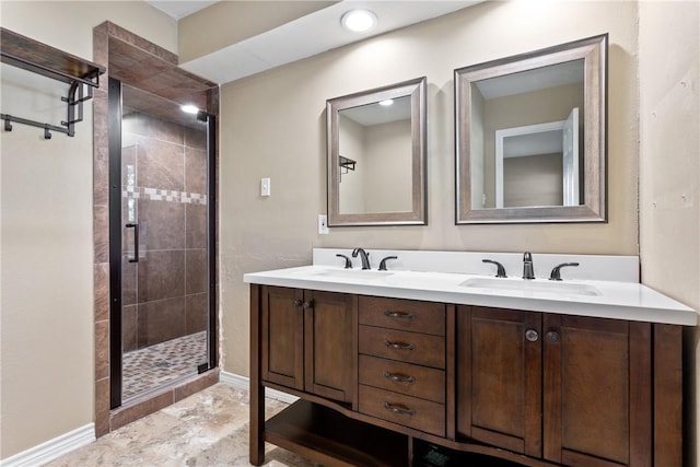 bathroom featuring a shower with door and vanity