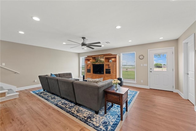 living room with ceiling fan and light hardwood / wood-style floors