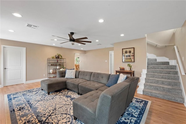 living room featuring ceiling fan and light wood-type flooring