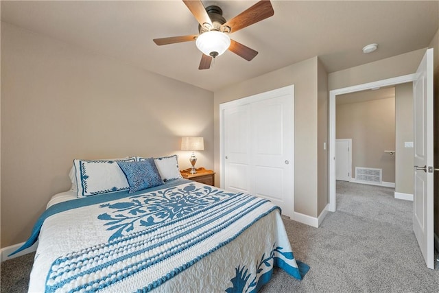 carpeted bedroom with ceiling fan and a closet