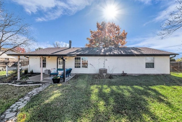 rear view of property with central air condition unit, a patio area, and a lawn