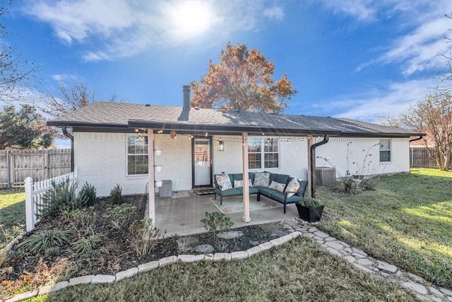 view of front of house with a patio area, an outdoor hangout area, a front yard, and central air condition unit