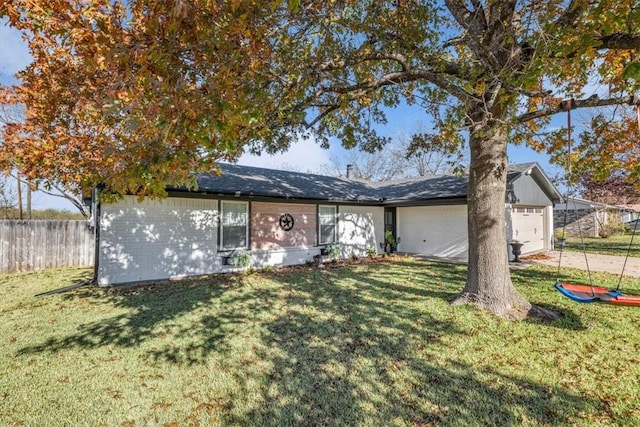 view of front of home with a front yard and a garage