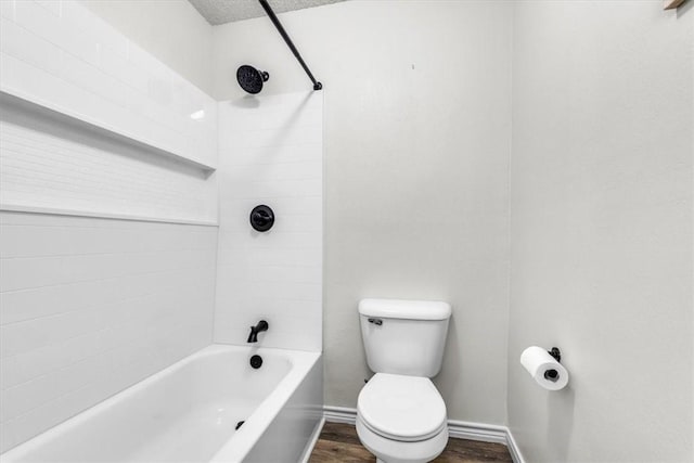 bathroom featuring a textured ceiling, hardwood / wood-style floors, bathtub / shower combination, and toilet