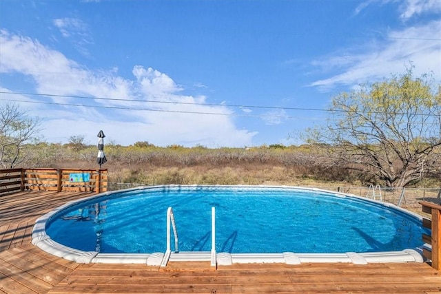 view of swimming pool featuring a deck