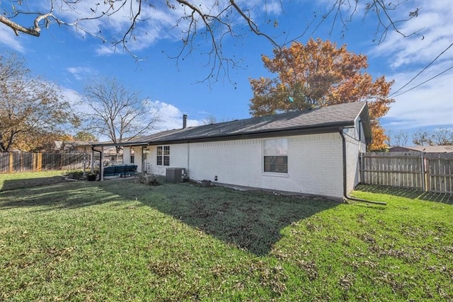 back of house with a yard and cooling unit