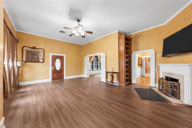 unfurnished living room with hardwood / wood-style floors, crown molding, a fireplace, and ceiling fan