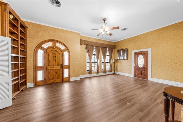 entryway with ornamental molding, wood-type flooring, and ceiling fan