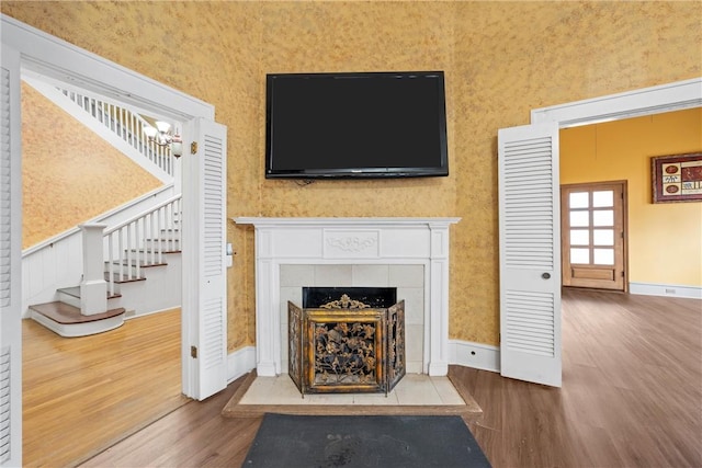 living room with a fireplace and wood-type flooring