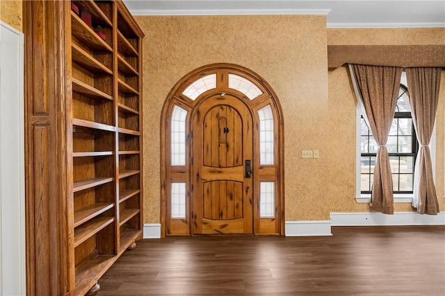 entryway featuring crown molding and dark hardwood / wood-style floors