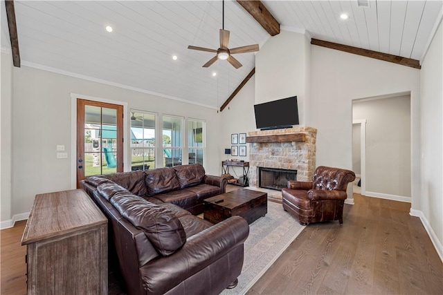 living room with ceiling fan, high vaulted ceiling, wooden ceiling, hardwood / wood-style floors, and a stone fireplace