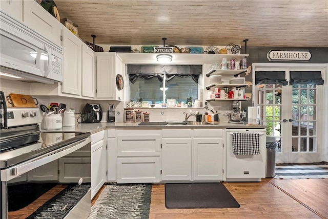 kitchen with light hardwood / wood-style flooring, white cabinets, white appliances, and sink