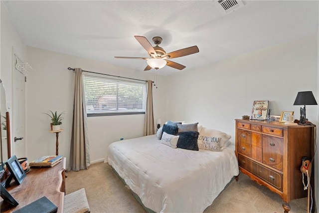 bedroom featuring ceiling fan and light carpet