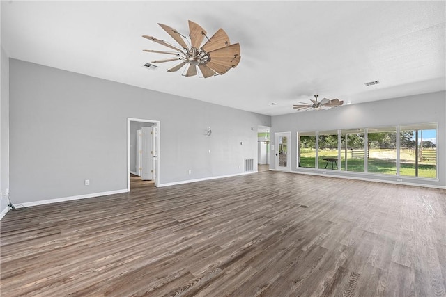 unfurnished living room featuring ceiling fan and dark hardwood / wood-style flooring