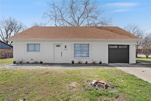 ranch-style house with driveway, brick siding, an attached garage, and a front yard