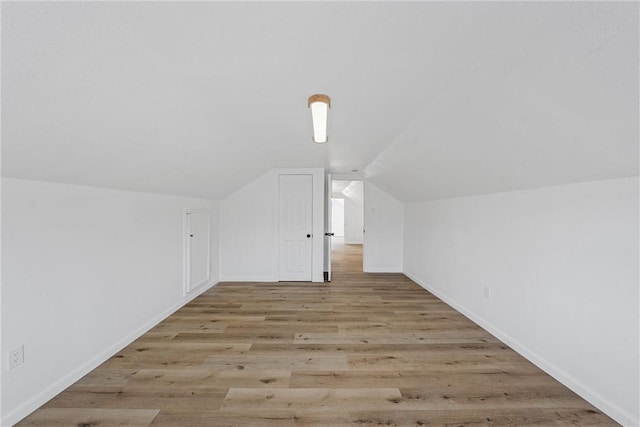 bonus room with vaulted ceiling, baseboards, and wood finished floors