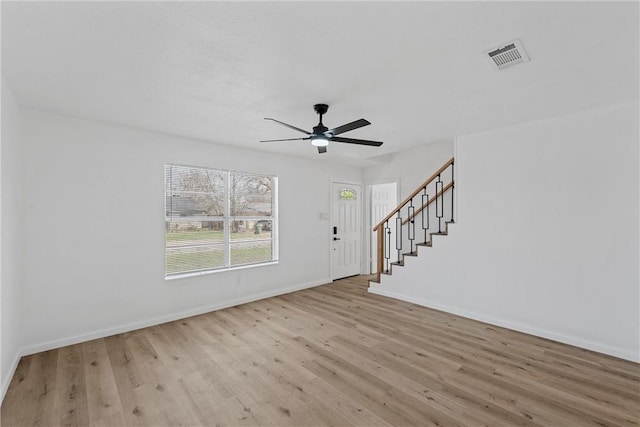 interior space with visible vents, stairway, a ceiling fan, wood finished floors, and baseboards