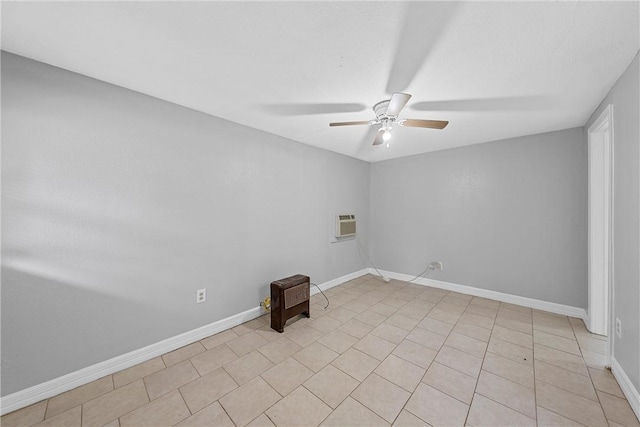 unfurnished room featuring baseboards, an AC wall unit, and ceiling fan