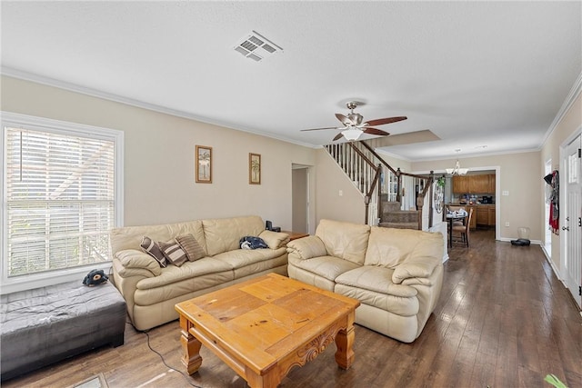 living room featuring visible vents, ornamental molding, a ceiling fan, hardwood / wood-style flooring, and stairs