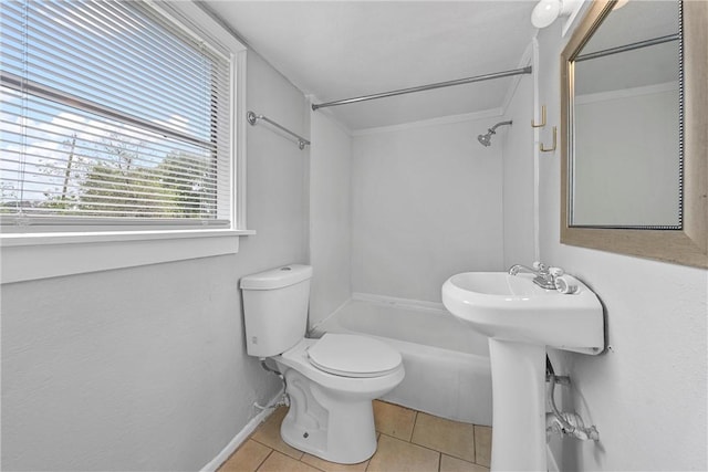 bathroom featuring tile patterned floors, toilet, baseboards, and shower / bath combination