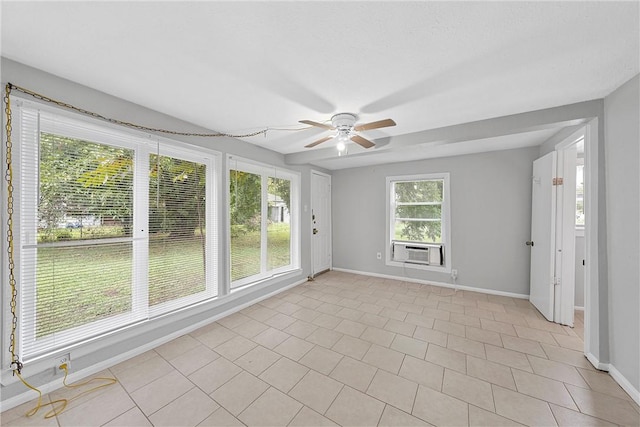 spare room featuring cooling unit, a ceiling fan, baseboards, and light tile patterned floors