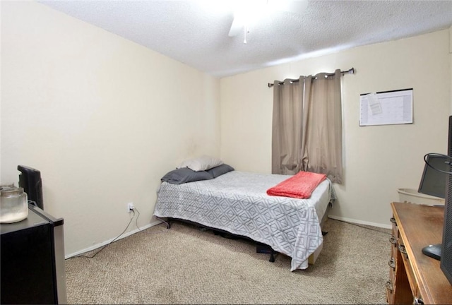 carpeted bedroom with ceiling fan and a textured ceiling