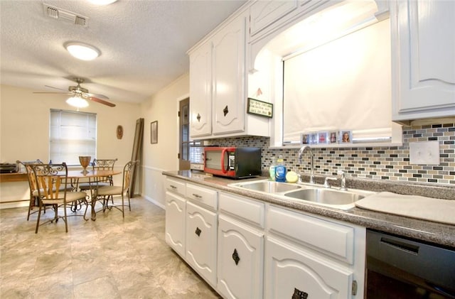 kitchen with sink, dishwasher, ceiling fan, white cabinetry, and decorative backsplash