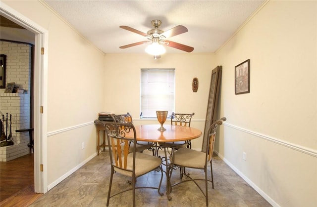 dining room with ornamental molding, a wood stove, a textured ceiling, and ceiling fan