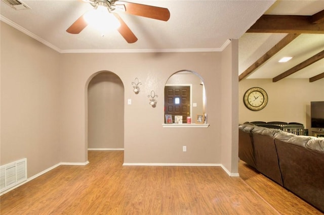 interior space featuring beamed ceiling, ceiling fan, crown molding, and light hardwood / wood-style floors