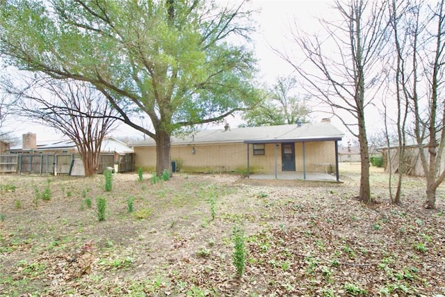 back of property with a patio