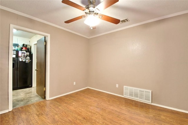 empty room featuring wood-type flooring, a textured ceiling, ceiling fan, and crown molding