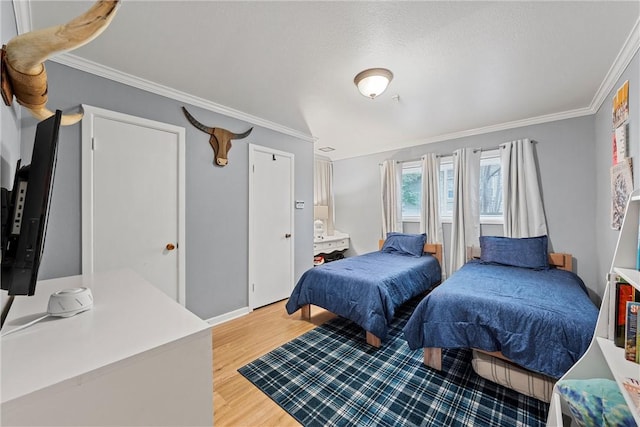 bedroom featuring ornamental molding and light wood-type flooring