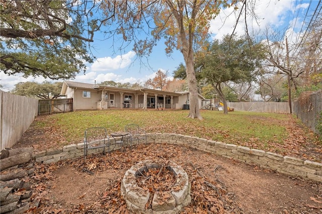 rear view of house featuring a yard