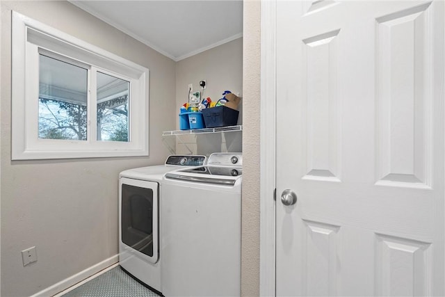 laundry area with washer and clothes dryer and ornamental molding