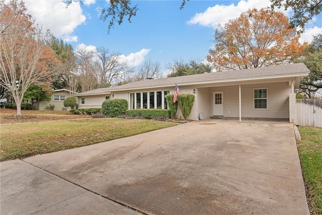 ranch-style house featuring a front yard and a carport