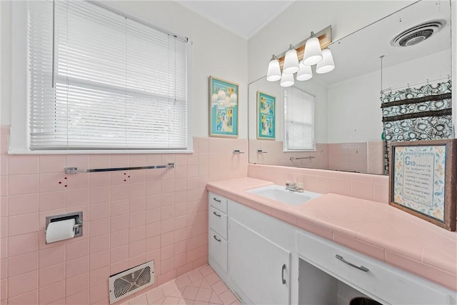 bathroom featuring tile patterned floors, vanity, and tile walls