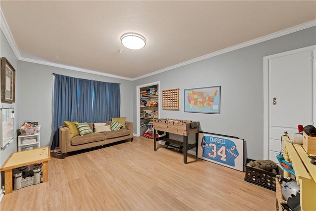 living room with hardwood / wood-style floors, a textured ceiling, and ornamental molding