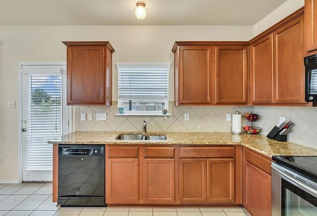 kitchen featuring decorative backsplash, sink, and black appliances