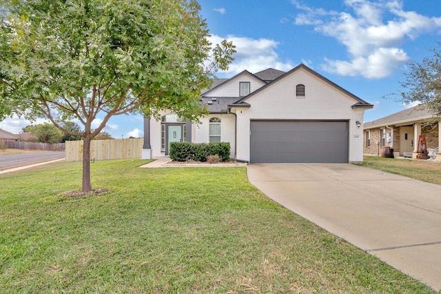 view of front of house with a front yard and a garage